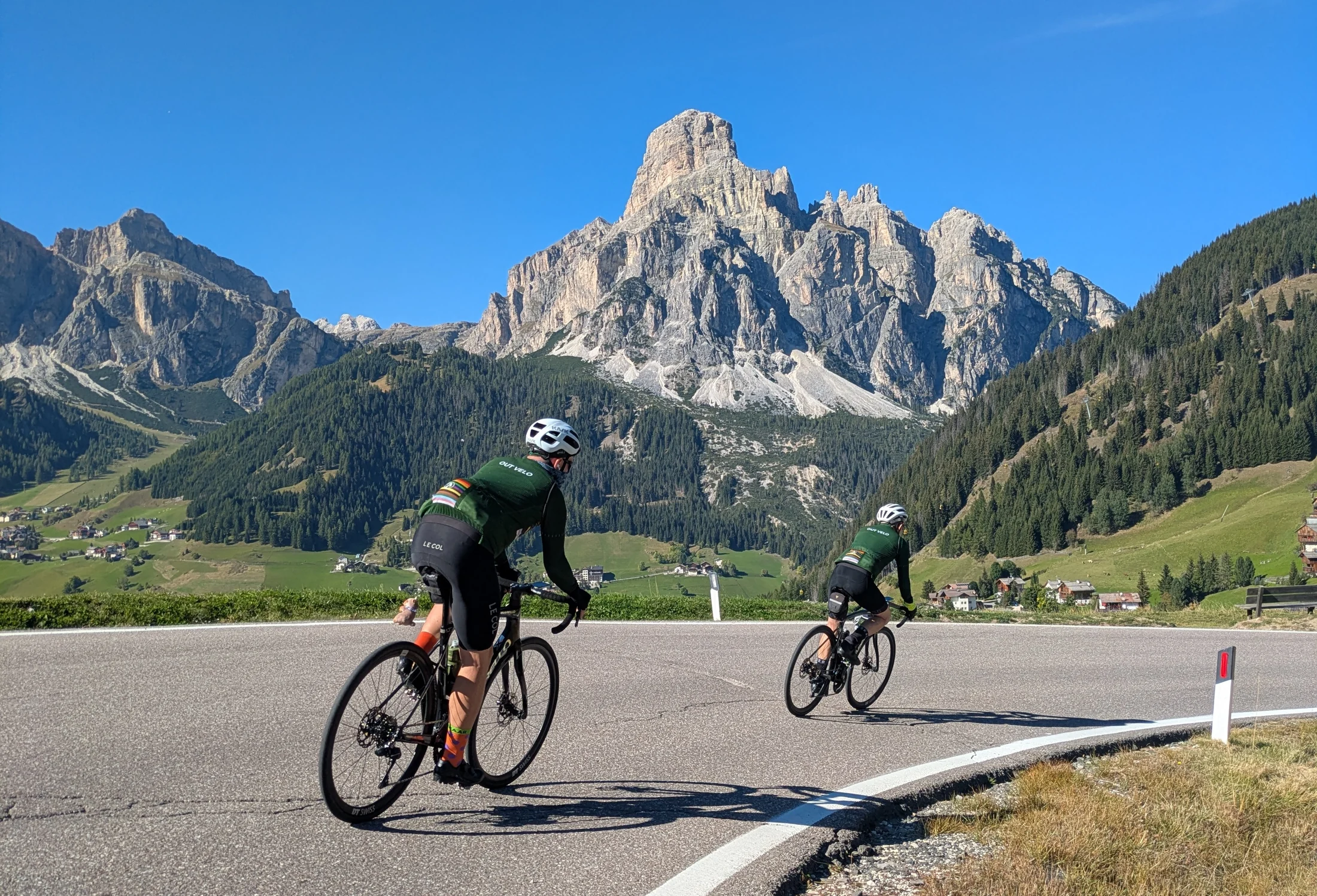 Out Velo riders beneath the Dolomites